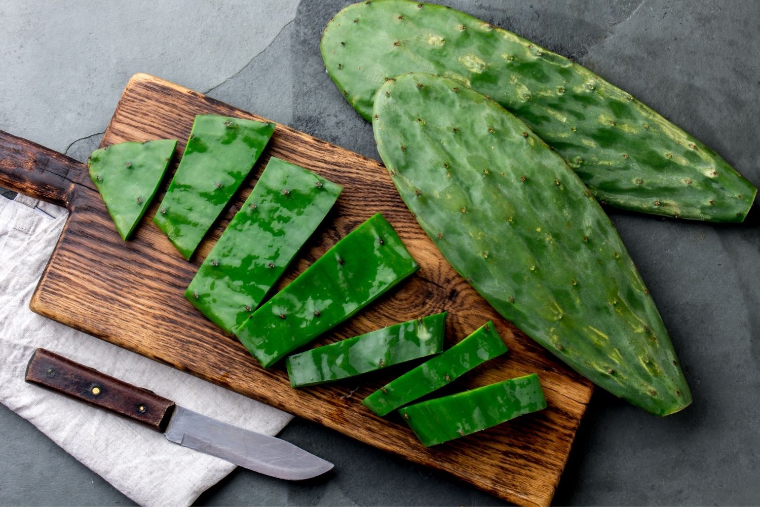 Nopales on a wooden board with knife