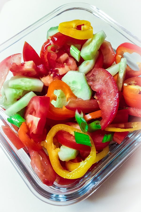 Quick Tomato Cucumber And Pepper Summer Salad is a delicious recipe that uses fresh tomatoes, cucumbers and peppers tossed in vegetable oil and salt. Tomato Cucumber Salad in a glass bowl