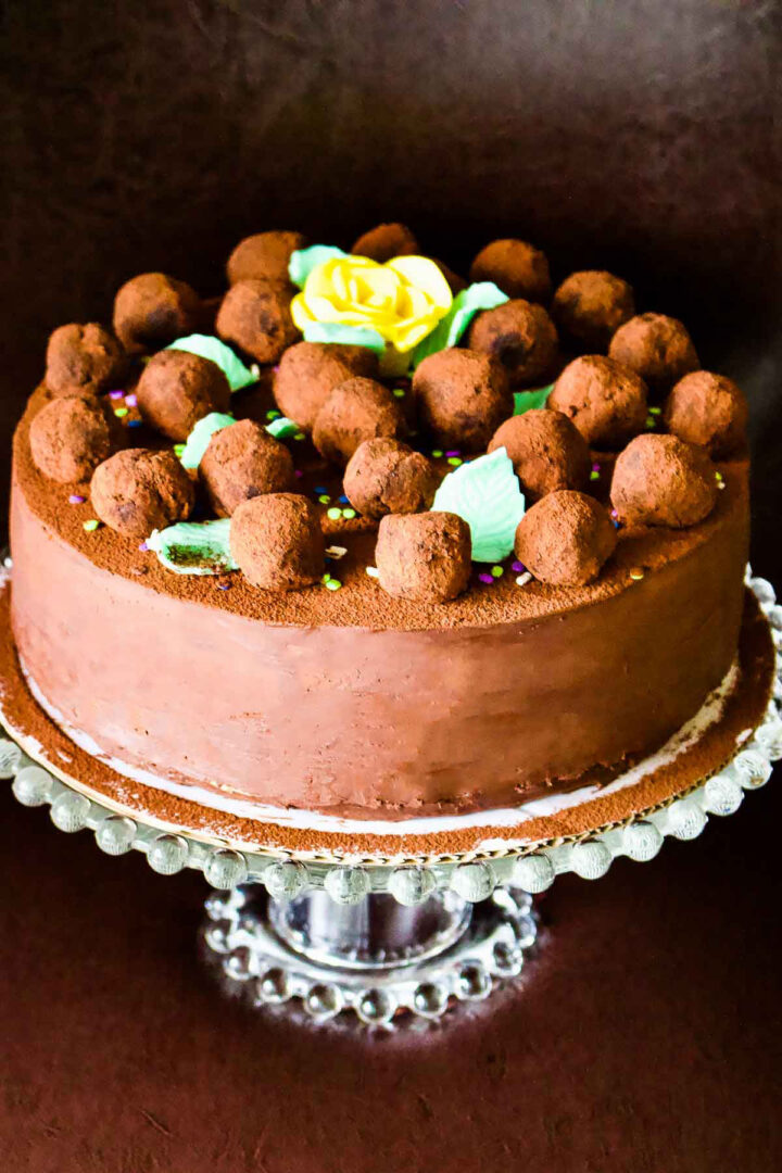This Gourmet Chocolate Mint Cake is perfect for a birthday celebration/graduation party. The delicate flavor of mint combines perfect with the chocolate. Chocolate Mint Cake on a glass cake stand.