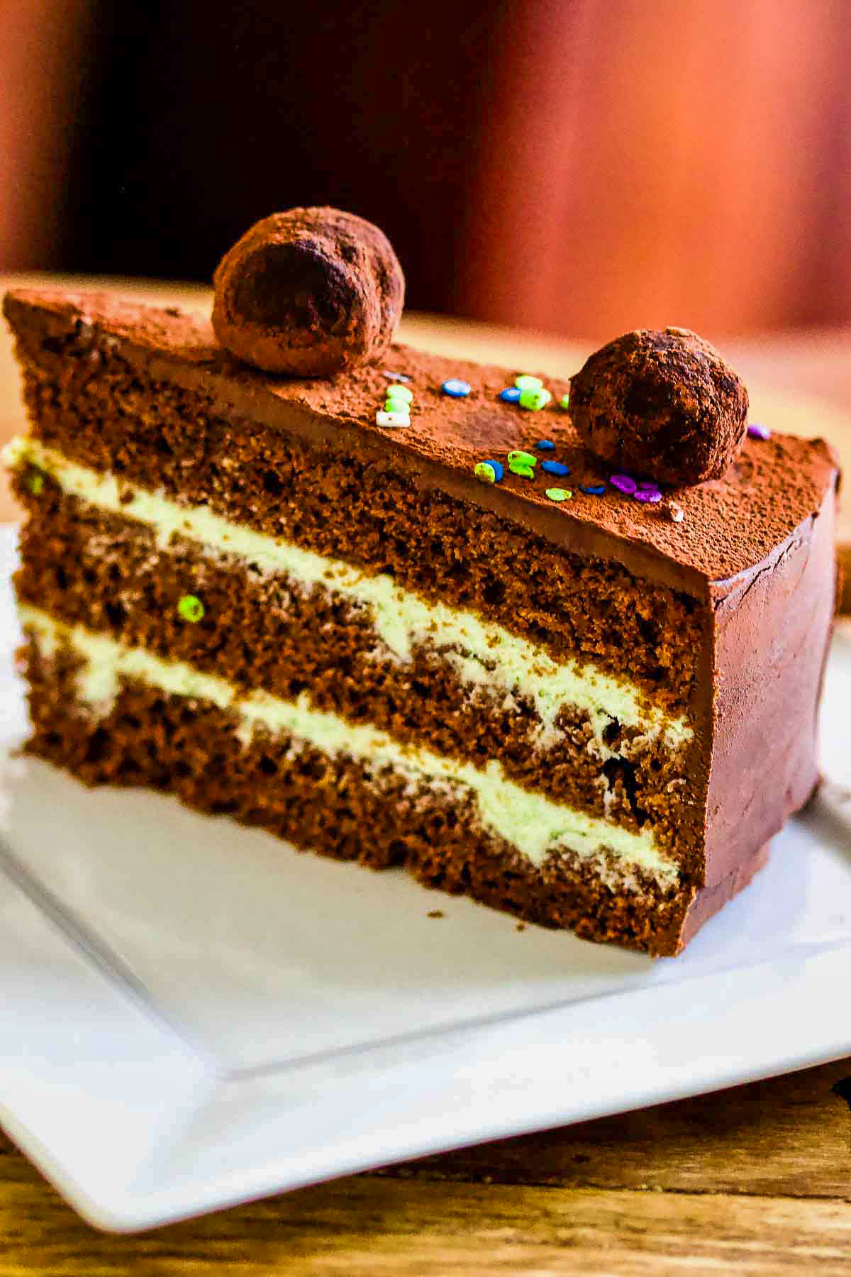 Slice of Mint Chocolate Cake on white plate.