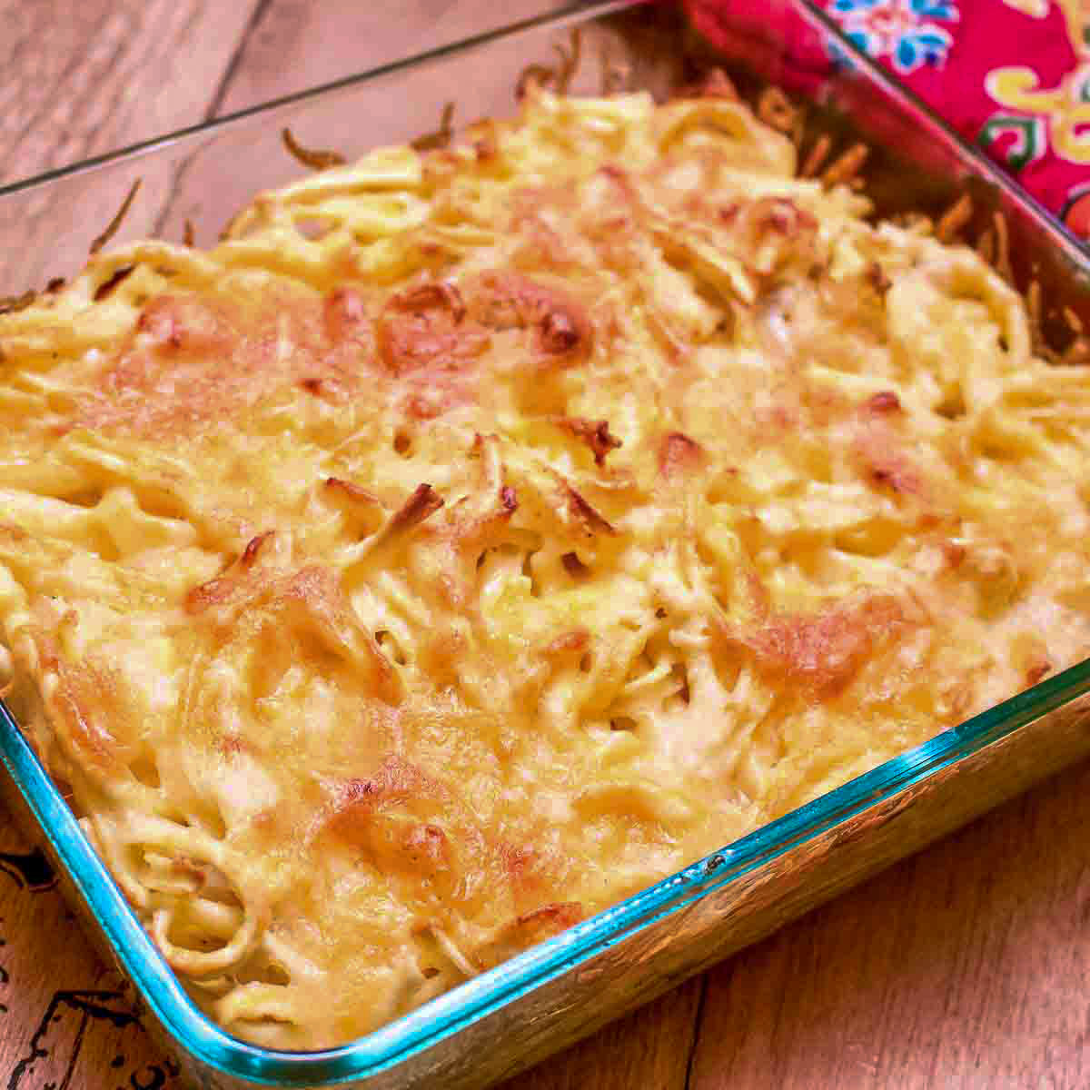 Spaetzle Pasta With cheese and onions in a glass pan.
