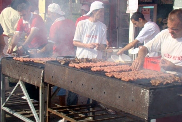 Mititei- Romanian Grilled Sausages are made with ground beef, garlic and other spices. They are served with mustard, bread, and cold beer. Mititei- Romanian Grilled Sausages grilled during a Bucharest city festival