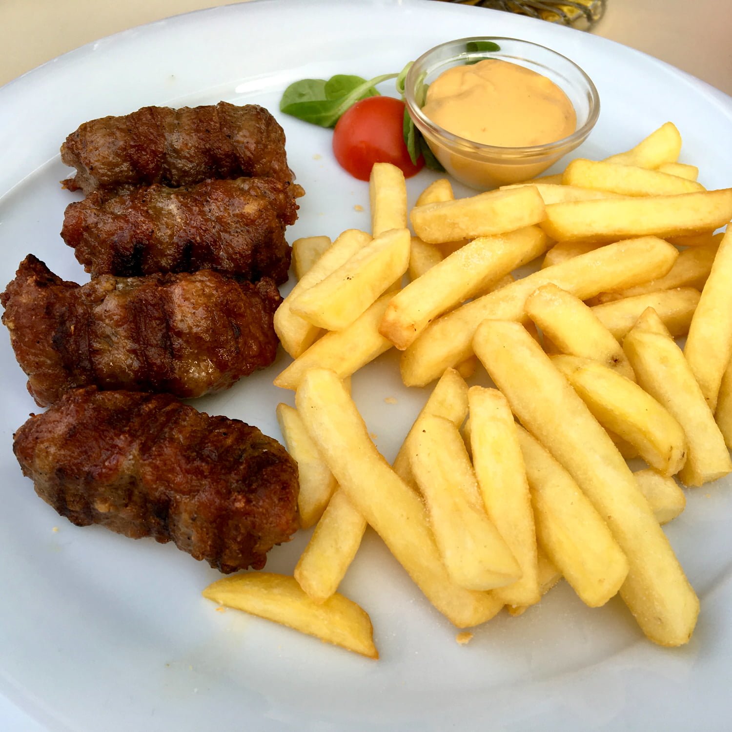Mititei- Romanian Grilled Sausages are made with ground beef, garlic and other spices. They are served with mustard, bread, and cold beer. Mititei- Authentic Romanian Grilled Sausages- featured pictures
