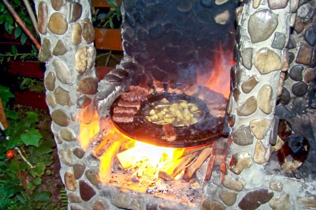 Mititei- Romanian Grilled Sausages are made with ground beef, garlic and other spices. They are served with mustard, bread, and cold beer. Mititei- Romanian Grilled Sausages grilled on a round pan with French Fries in the middle cooking in lard