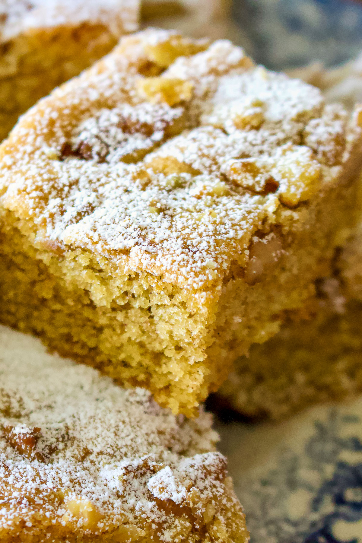 This walnuts and cinnamon coffee cake is an old Saxon recipe coming from Transylvania. My German grandma used to make this recipe very often. The cake is made from a simple batter with butter, sugar, eggs, flour and spices. Before it goes in the oven, the batter is sprinkled with walnuts. Great for breakfast too! Walnut and cinnamon coffee cake close up image0