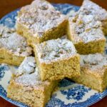 Walnuts And Cinnamon Coffee Cake slices on white and blue plate.
