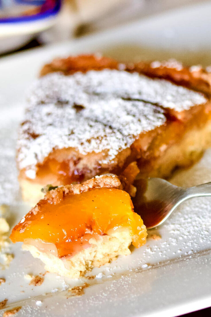 German Peach Kuchen- a Transylvanian dessert made with peaches, custard and a shortbread crust. Delicious, easy to make and perfect for summer. Best Peach Kuchen slice vertical photo11