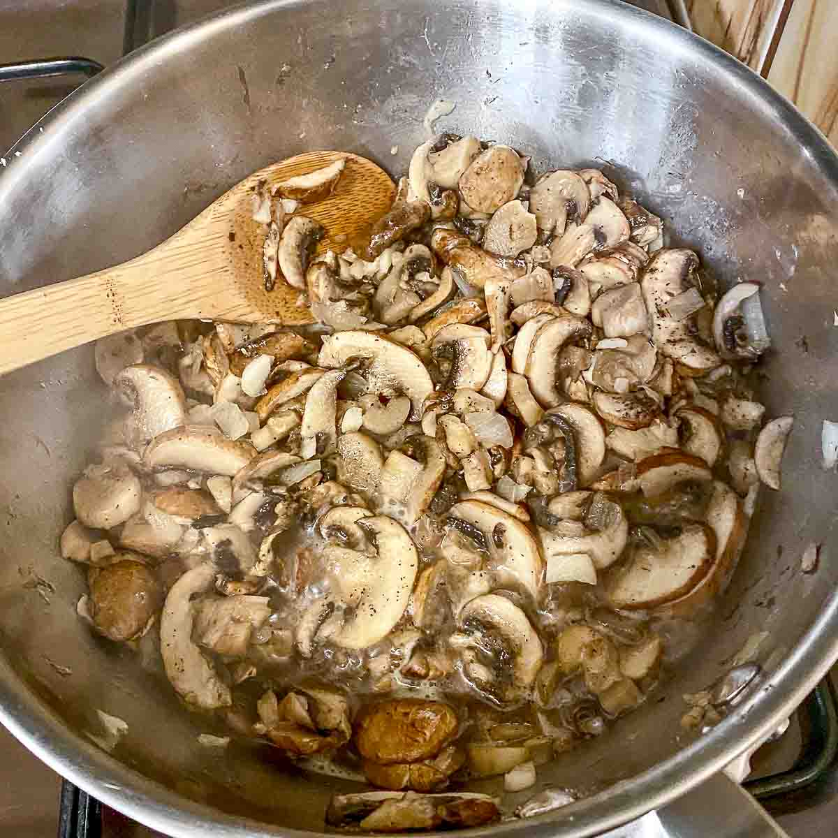 Mushrooms cooking in a pan.