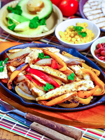 Mexican chicken fajitas with toppings in the background square photo0