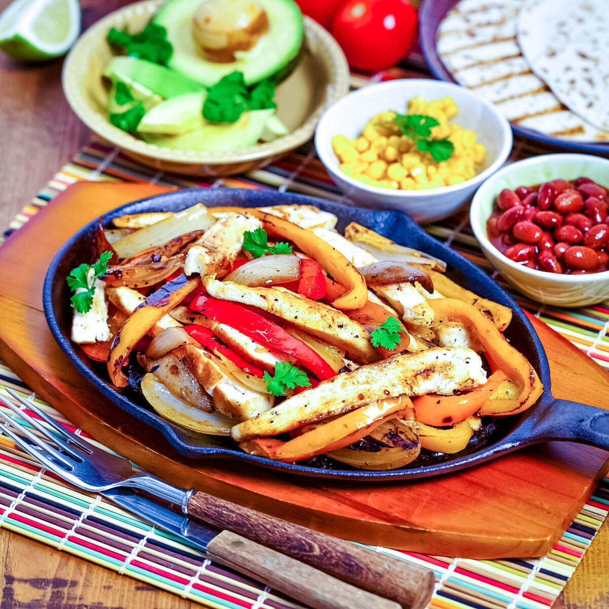Mexican chicken fajitas with toppings in the background square photo0