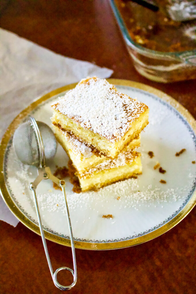 Lemon Ricotta Cheese Cake slices stacked on white plate0