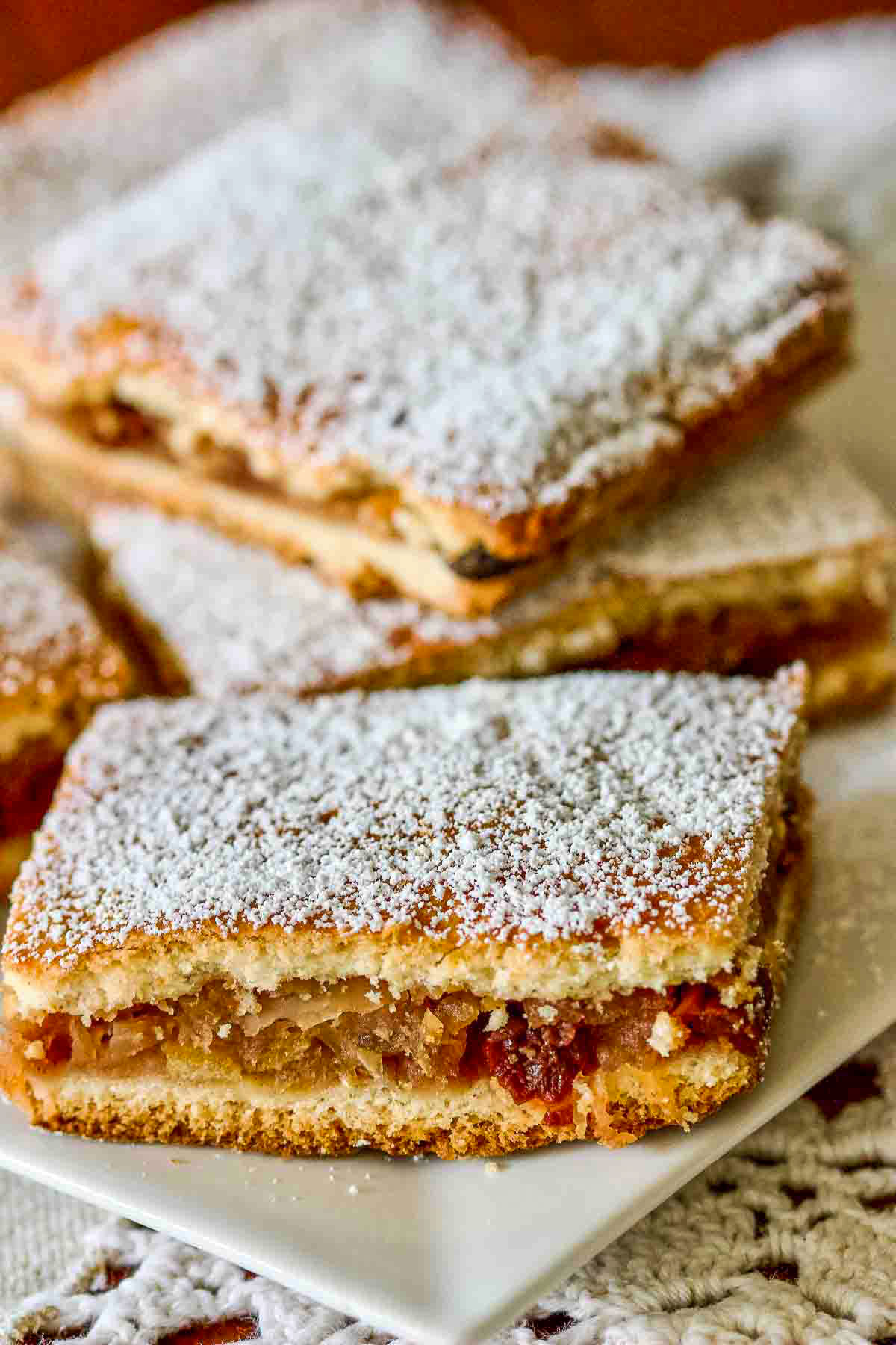 Slab Apple Pie Romanian Style slices stacked on a white plate.