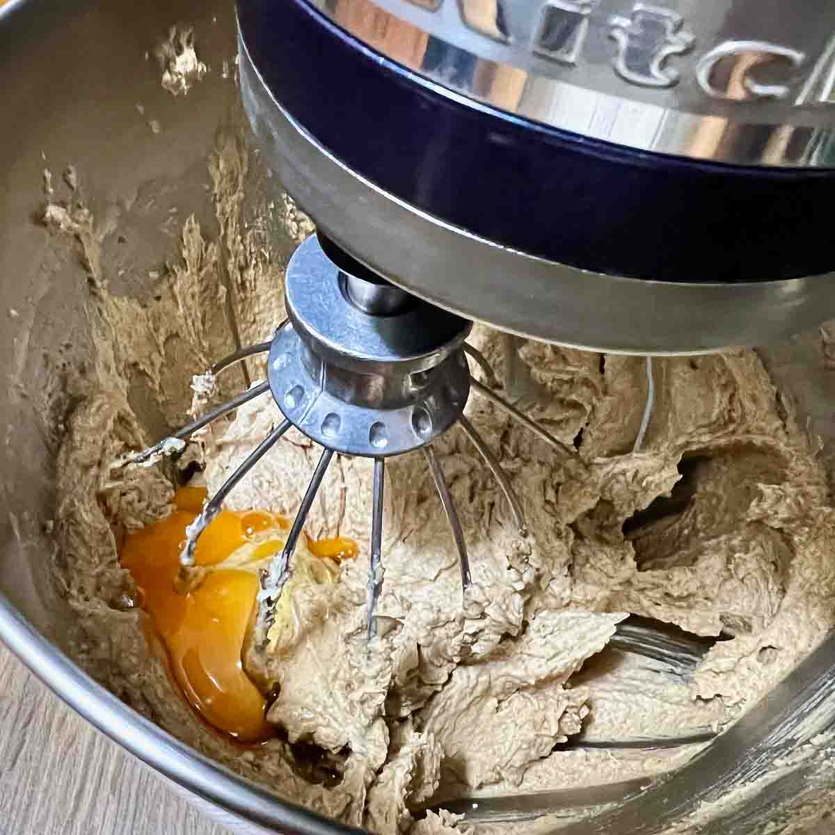 Adding eggs and vanilla to the batter.