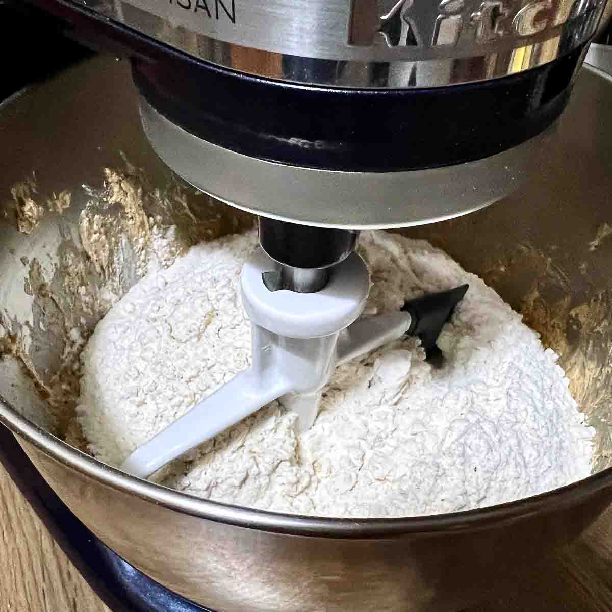 Adding flour to the batter.