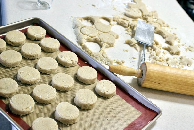 dough for polvorones, with spatula an, baking tray with polvorones ready for bakingd rolling pin