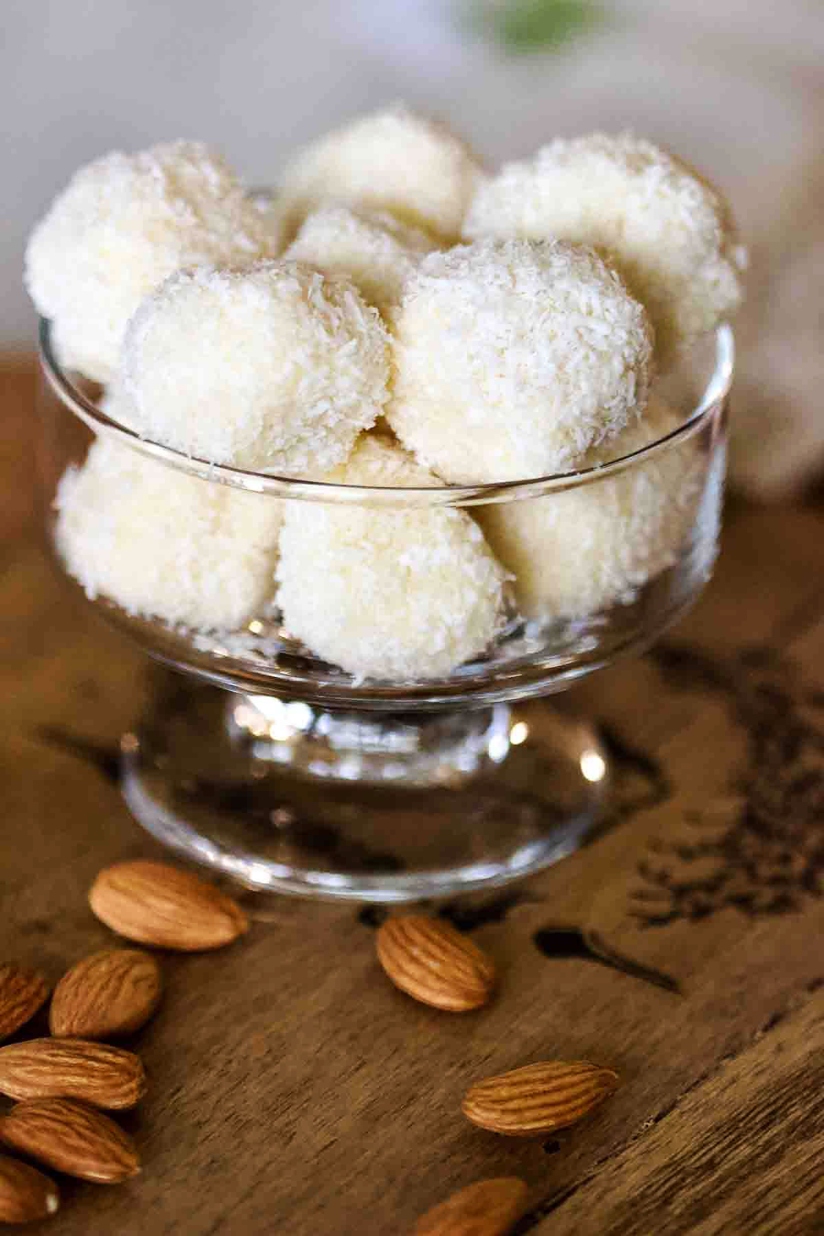 Homemade Raffaello Coconut and Almonds Confections Raffaello Coconut Confections in a glass bowl.