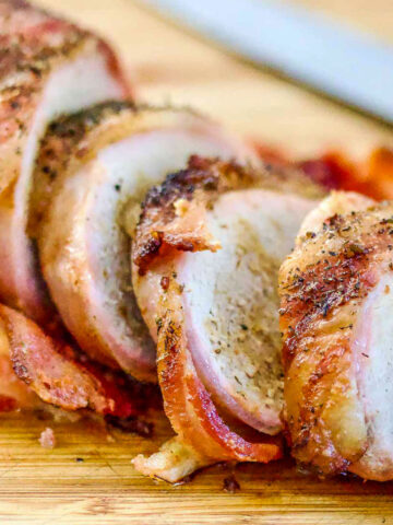 Roasted Pork wrapped in bacon on cutting board square image1200