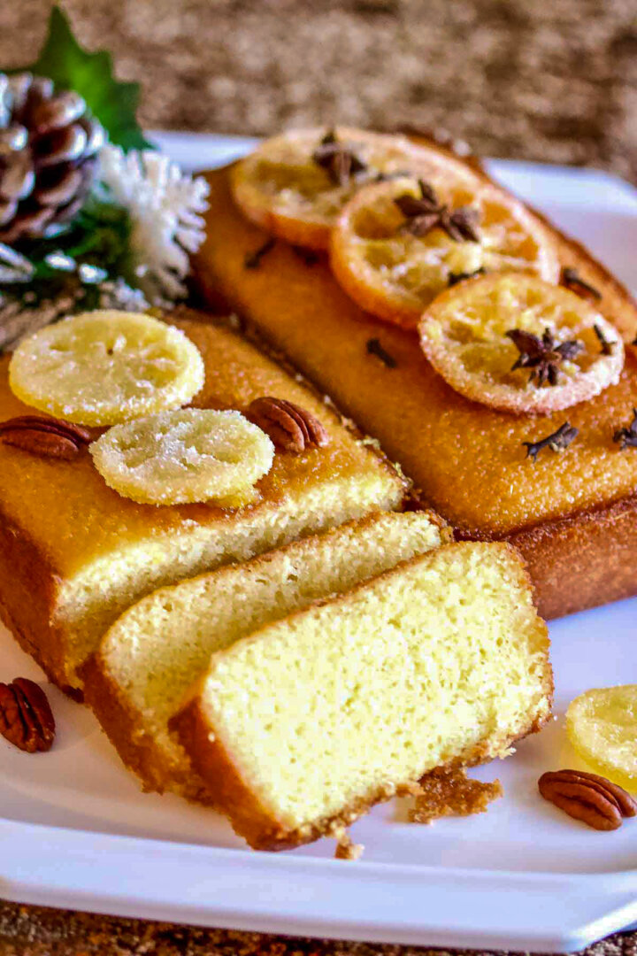 Lemon bread sliced and decorated with candied lemon slices.