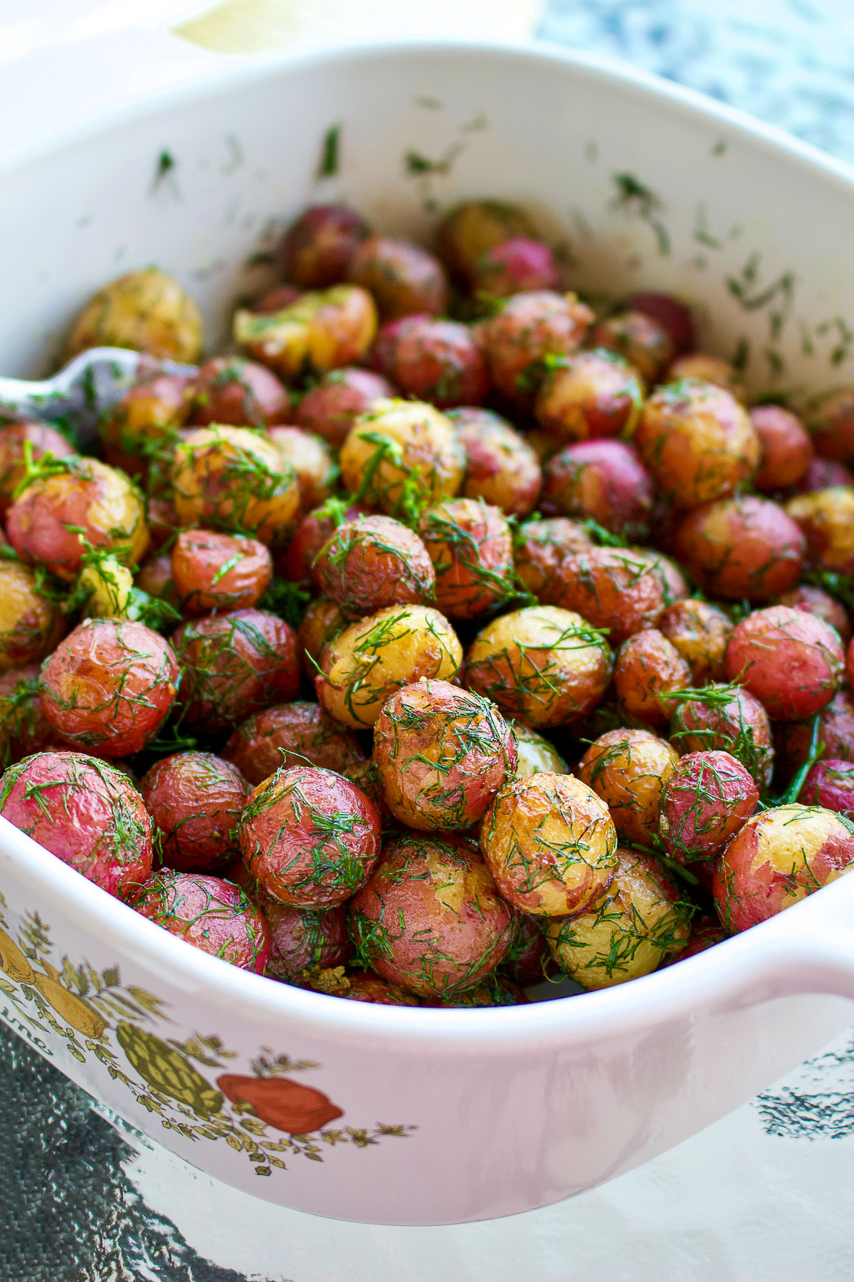 Baby potatoes with butter and dill close up