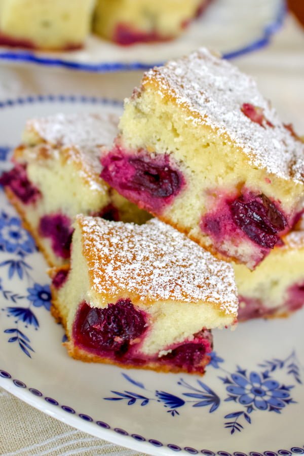 Pound Cake with Fruits and Almond Flakes- slices of cake on a white with blue flowers plate