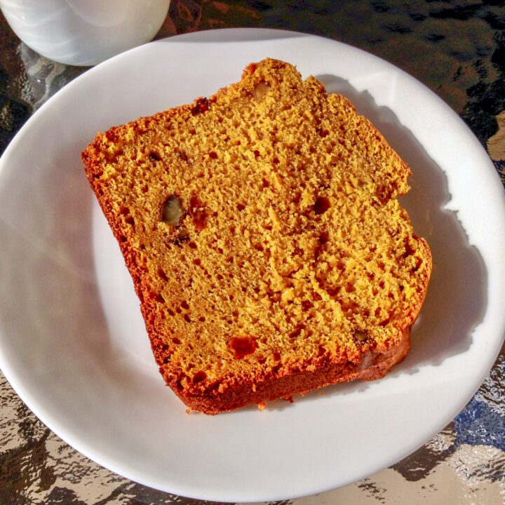 Pumpkin Bread With Walnuts And Raisins Recipe- slice of bread on white plate, close up