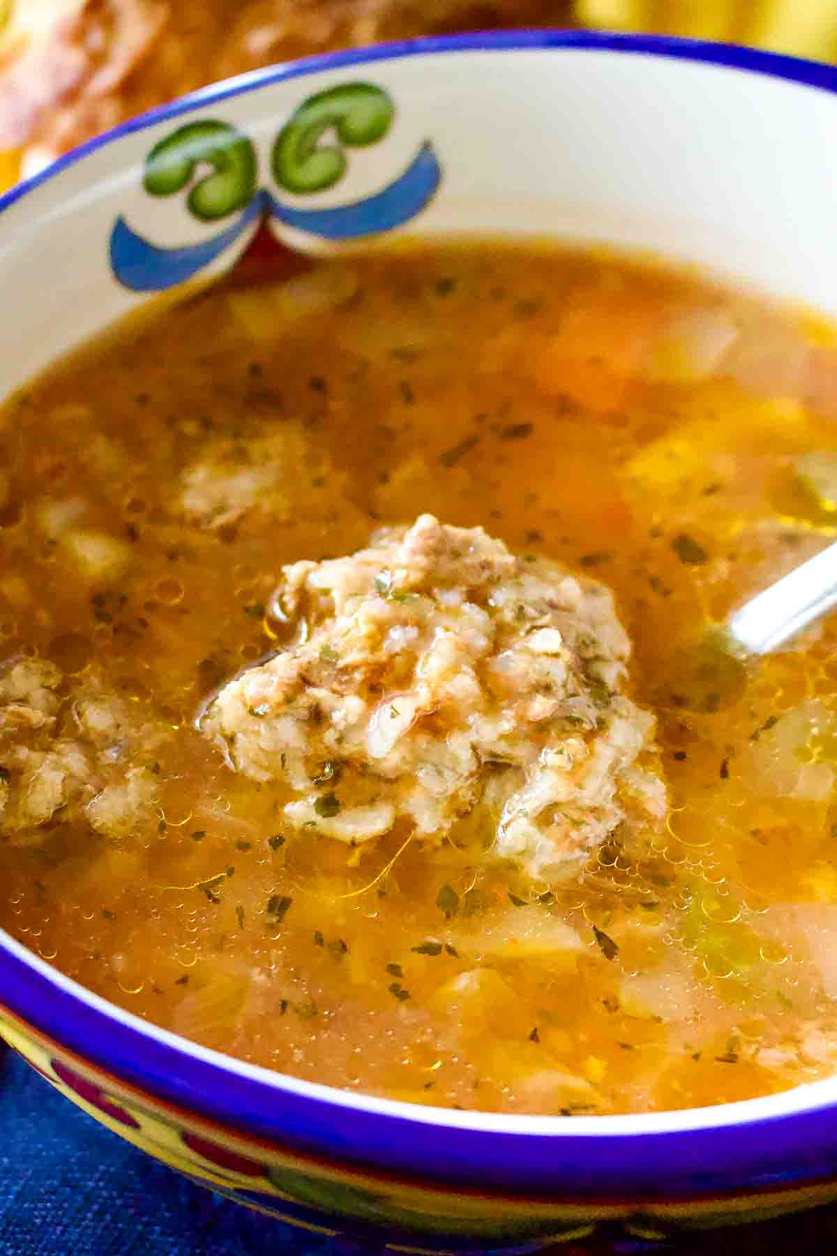 Romanian meatballs sour soup or Ciorba de Perisoare is one of the most traditional soups of the Romanian cuisine, and the pride of every Romanian cook. "Perisoare" means meatballs usually made with minced pork, beef or a combination of both mixed with rice, egg and spices, then boiled in the soup, or ciorba. Romanian Meatball Soup in a bowl.