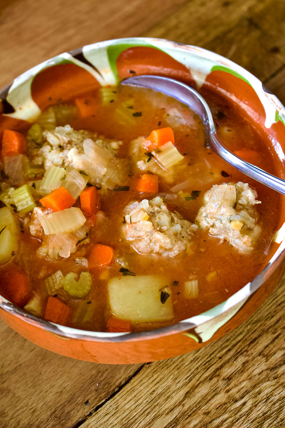 Romanian Meatballs Sour Soup in a bowl with spoon0
