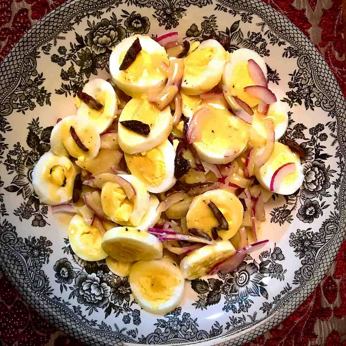 Romanian Potato Salad in a black and white salad bowl.