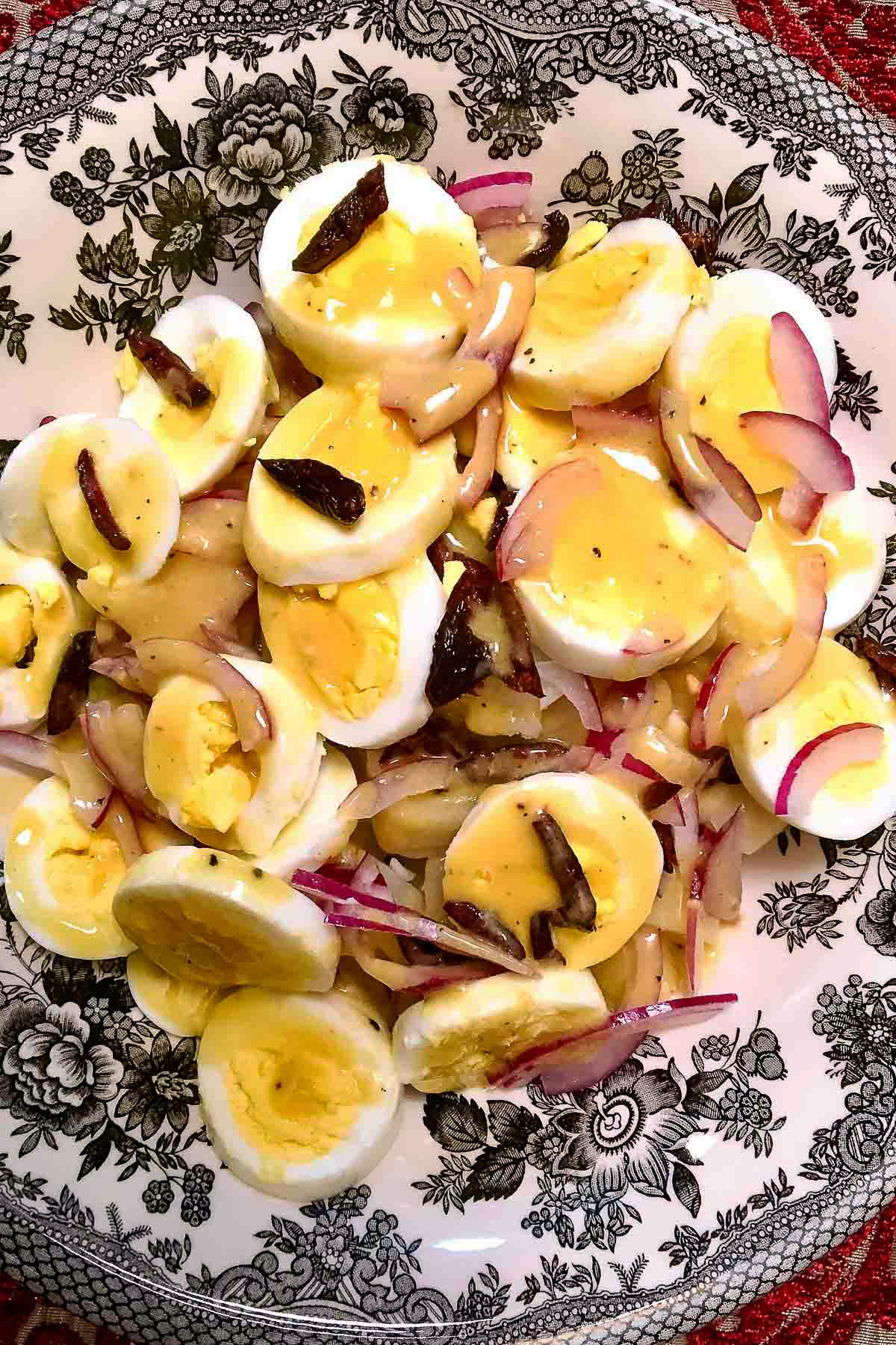 Romanian Potato Salad in a black and white salad bowl.