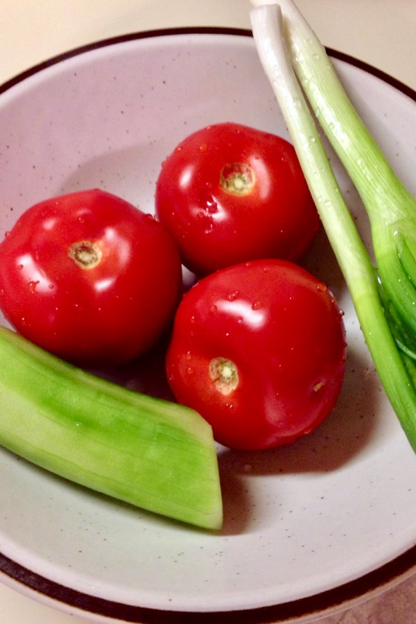Tomato Cucumbers Feta Salad Recipe is a traditional authentic Romanian salad that can be made all year round. The salad doesn't use vinegar or lemon juice in the dressing, only sunflower oil, salt and pepper. Simple and delicious! Tomatoes, Cucumbers, green onion in a bowl