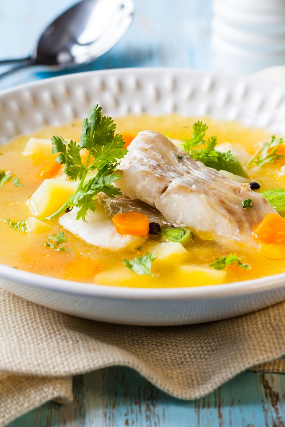 Sour Fish Soup Romanian style2 fish soup in a white bowl