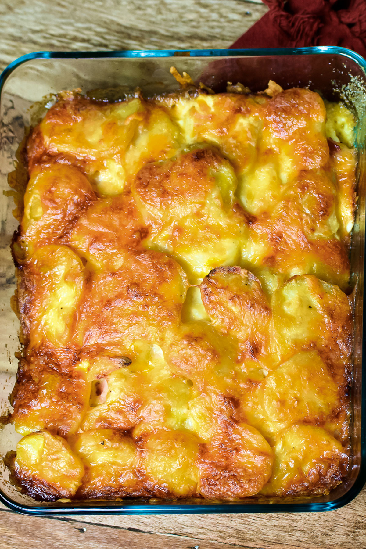 Potatoes Au Gratin with Ham and Eggs in a glass dish.