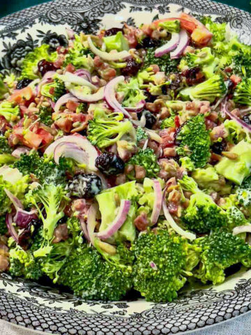 Best Broccoli salad with craisins served in a bowl.