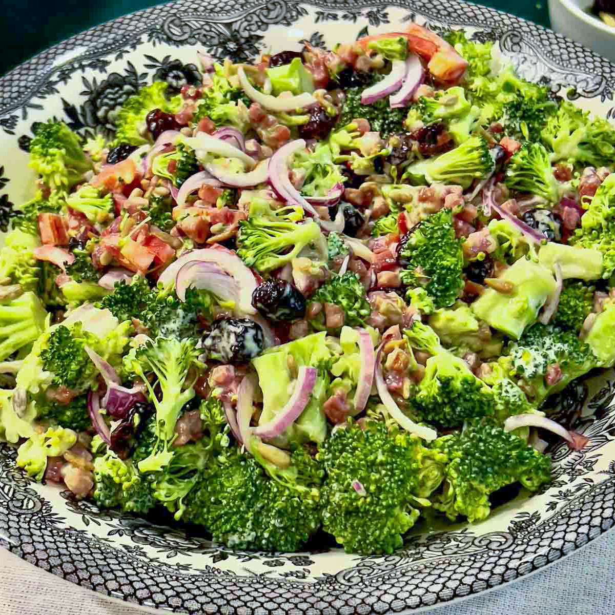 Best Broccoli salad with craisins served in a bowl.