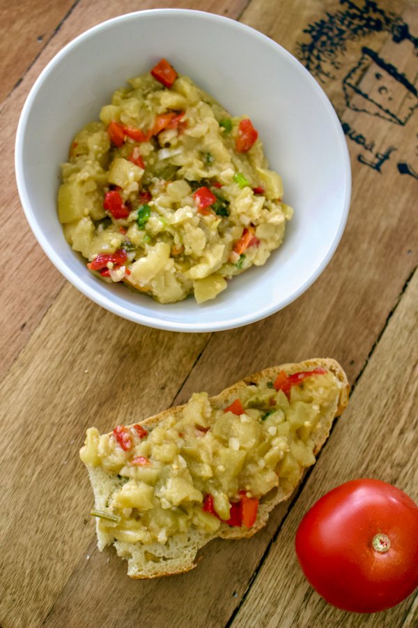 Grilled Eggplant And Bell Pepper Salad3 Grilled Eggplant And Bell Pepper Salad in a bowl next to a slice of bread and a tomato