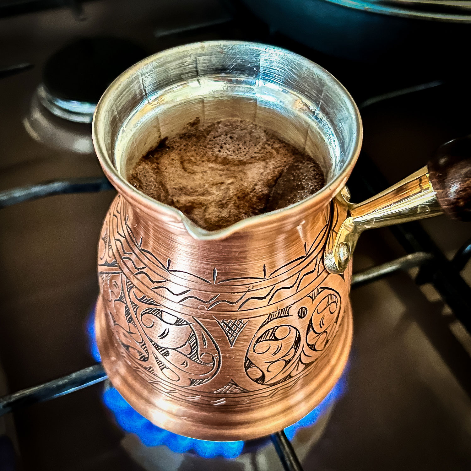 Ibrik on the stove with Turkish coffee simmering