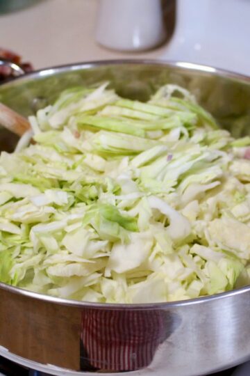 Shredded cabbage in the pan cooking