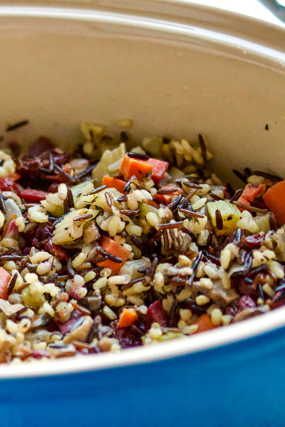 Vegetarian Wild Rice And Mushroom Stuffing1 Wild Rice Stuffing in a blue baking dish, close up.