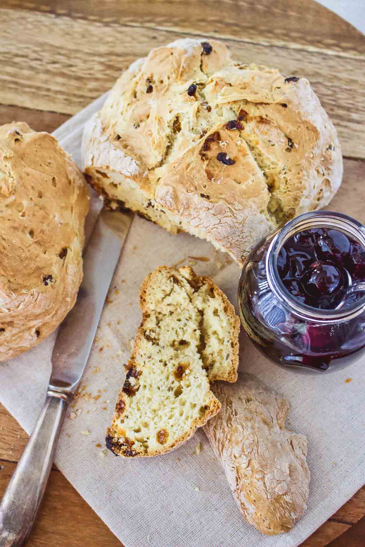 Irish American Soda Bread sliced on table, served with jam.