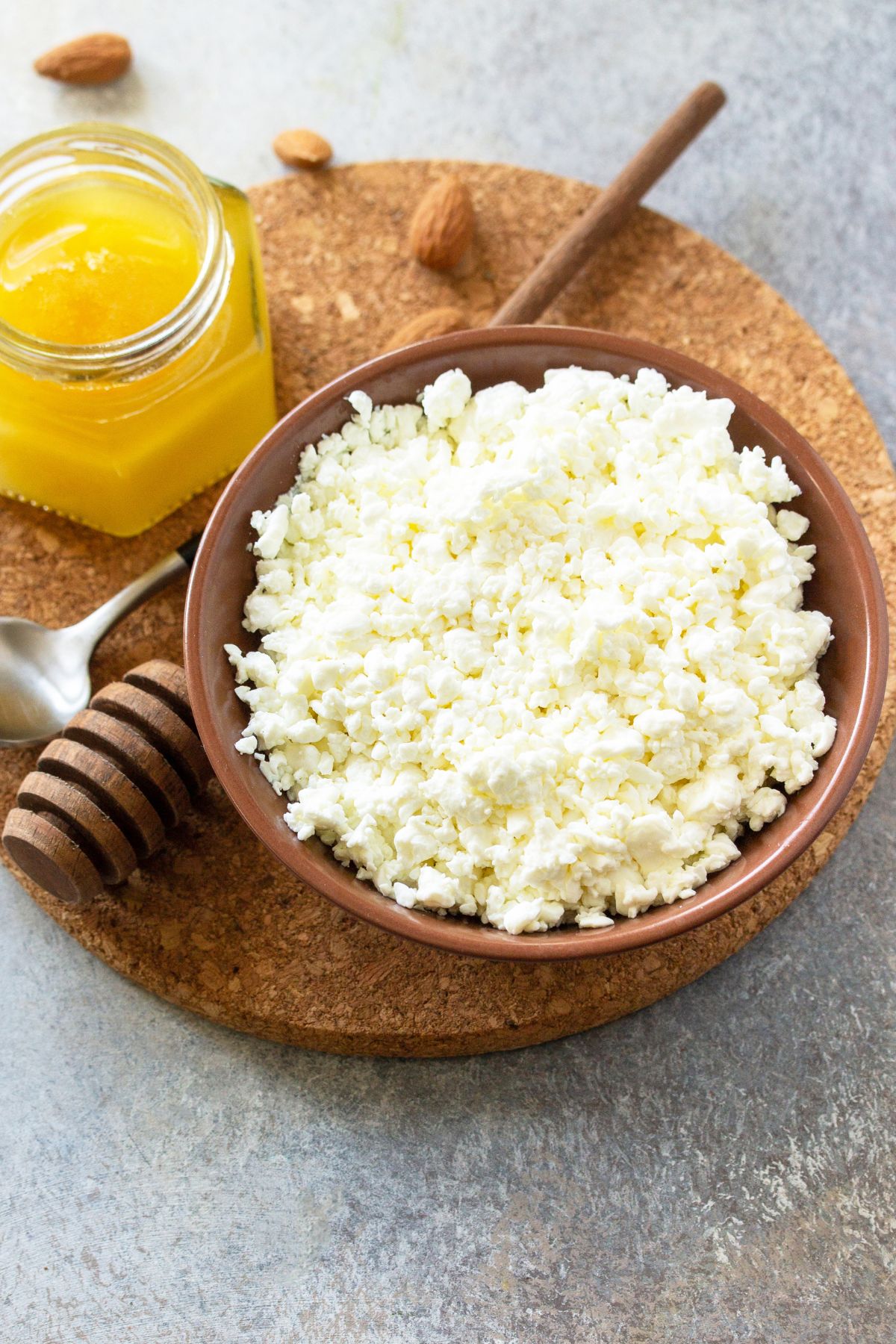Farmer's Cheese in a bowl with a jar of ghee in the background