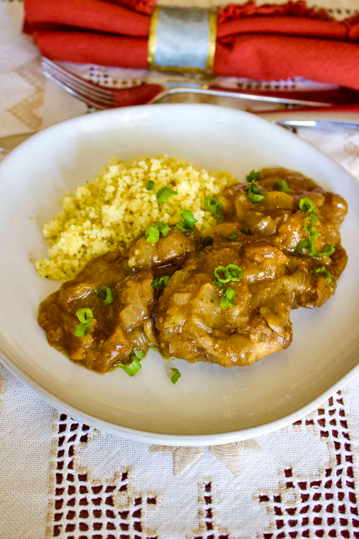 Moroccan Chicken with Figs And Couscous1 Moroccan Chicken with figs and couscous served on white plate.