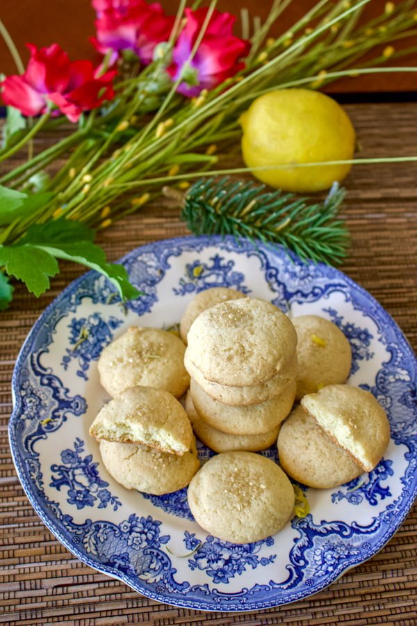 Olive oil lemon cookies with herb- overhead picture of stacked cookies on a white and blue plate