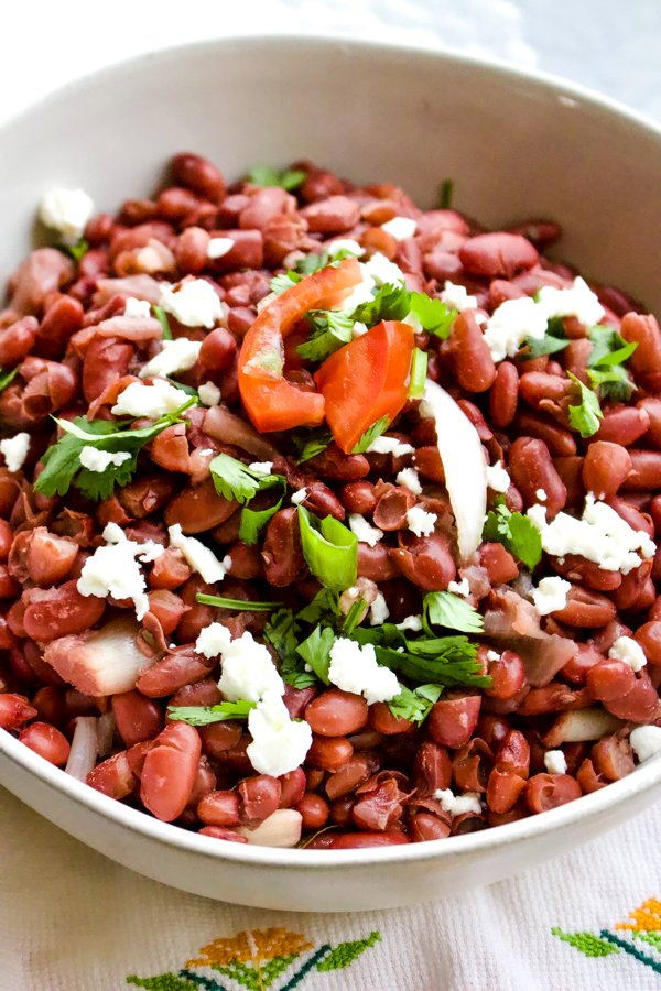 This is a basic authentic traditional Mexican beans recipe. The dish is nutritious, easy to make and so traditional that cannot miss from a respectable Mexican table. beans in a white bowl