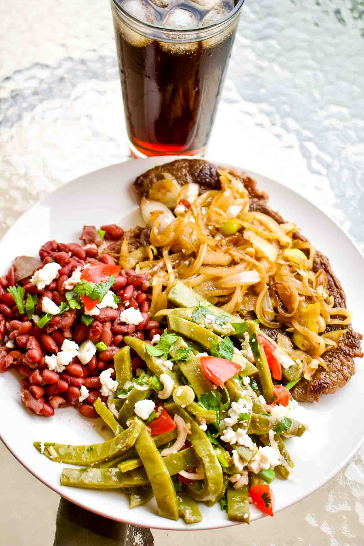 Mexican Beans seved with steak and cactus salad.