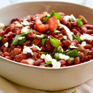 Mexican beans cooked and served with queso fresco.