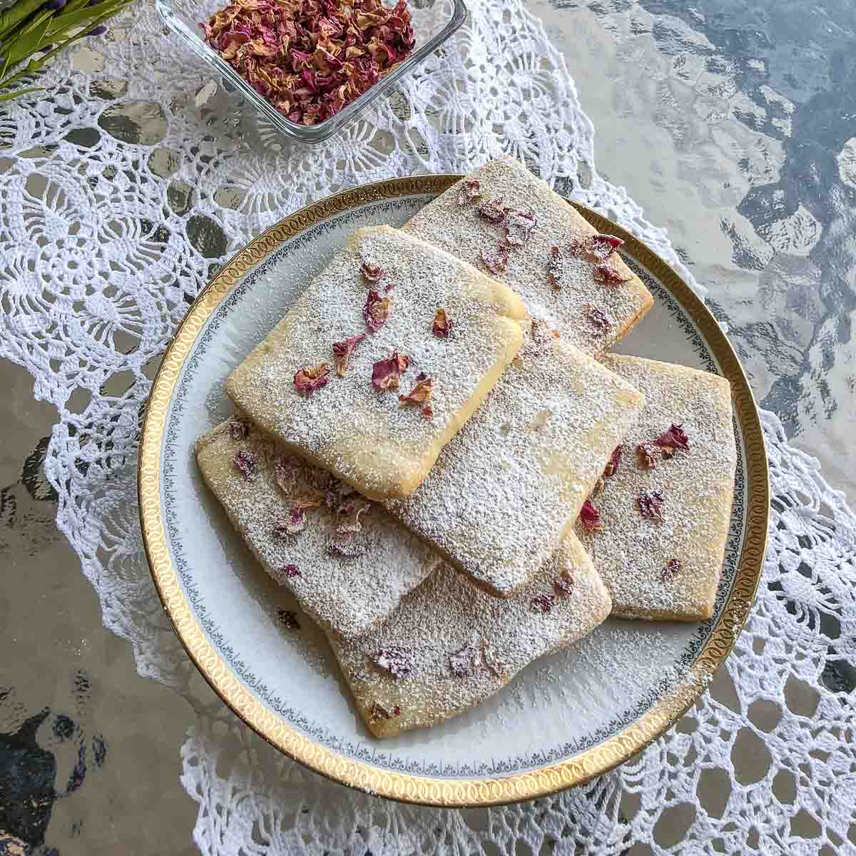 Rose Petal Butter Cookies on a white plate on table.