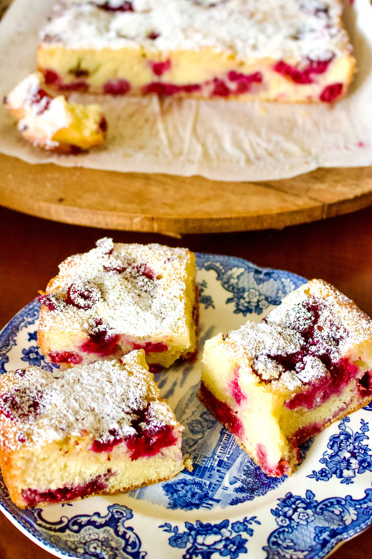 Buckle cake with berries on white and blue plate