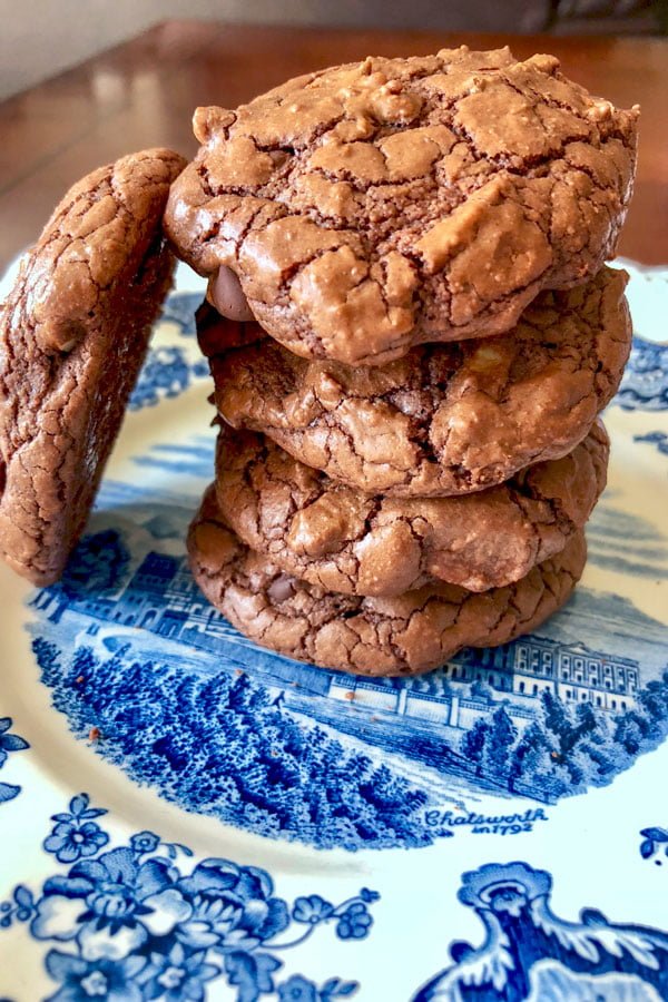 Easy Dark Chocolate Walnut Cookies- stacked cookies on a blue and white plate
