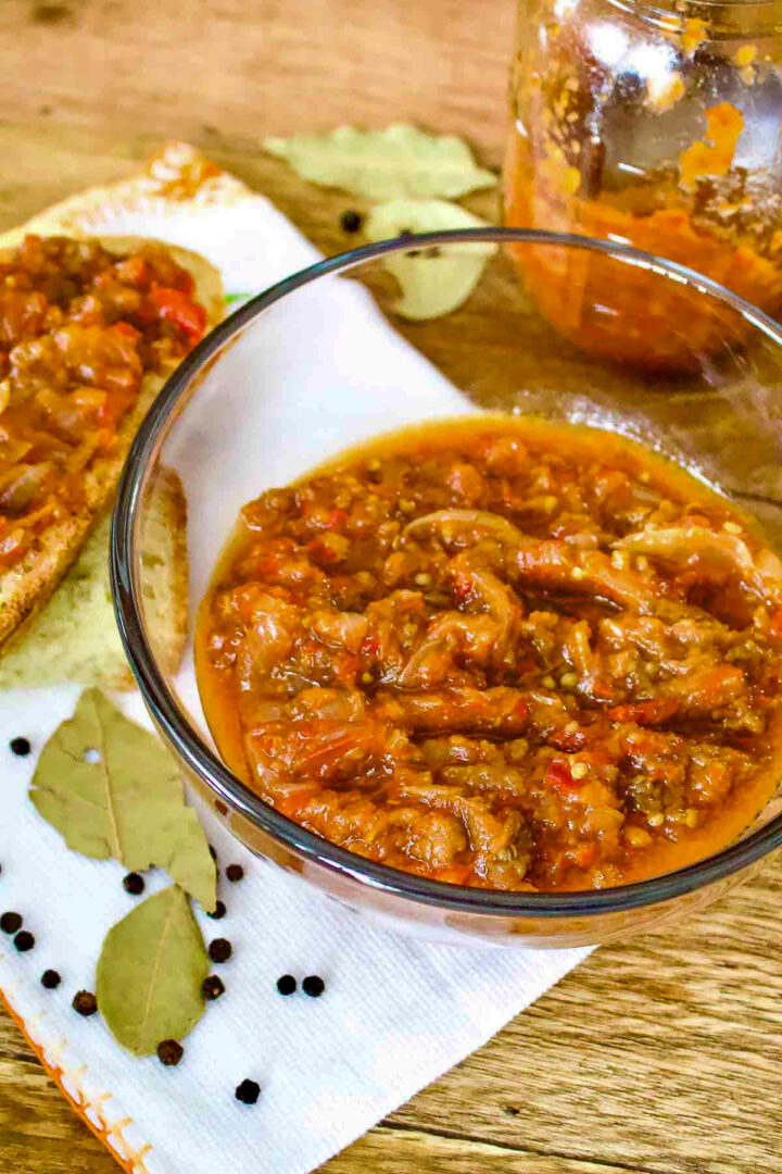 Zacusca vegetable spread on table in a glass bowl.
