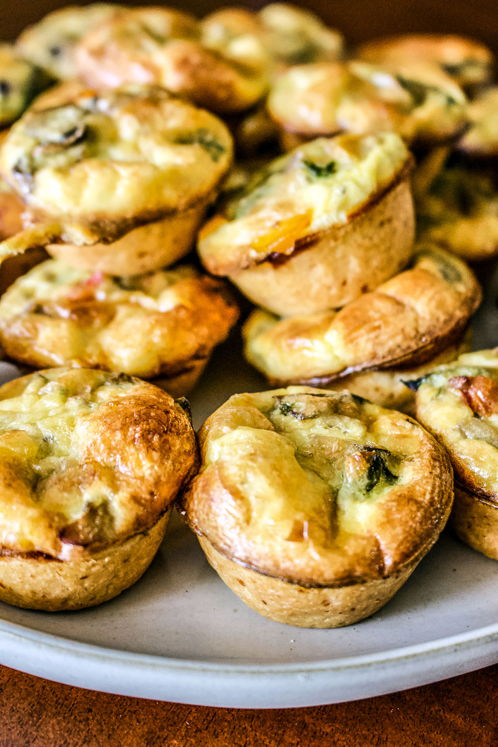 Baked Mini vegetarian quiche on a platter0